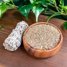 Load image into Gallery viewer, "Wooden bowl with dried white sage herbs, sage bundle, and green leaves on a wooden surface," - Down to Earth.