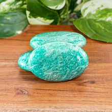 Load image into Gallery viewer, Amazonite Palm Stone up close group photo displayed on a styled background - Down To Earth