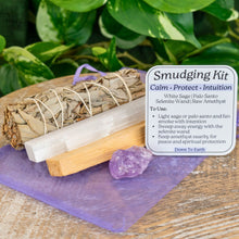 Load image into Gallery viewer, "Amethyst Smudging Kit that includes a piece of raw Amethyst, White Sage, Palo Santo, a 4'' Selenite Wand, a purple organza bag, and an info card," - Down to Earth.