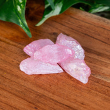 Load image into Gallery viewer, Rose Aura Quartz Raw on a wooden surface low angle - Down to Earth