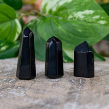 Load image into Gallery viewer, Black Obsidian Mini Points on a wooden surface with leaves in the foreground three of the points are pictured - Down to Earth