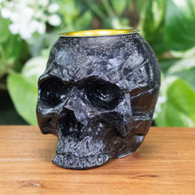 Load image into Gallery viewer, Black Skull Candle Holder angled displayed on a styled background - Down To Earth