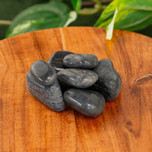 Load image into Gallery viewer, Black Tourmaline Tumbled on a wooden surface high angle - Down to Earth
