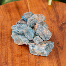 Load image into Gallery viewer, Blue Apatite Raw on a wooden surface high angle - Down to Earth
