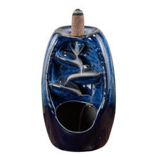 Load image into Gallery viewer, "Front of a Blue Ceramic Backflow Burner with an incense cone on top with smoke streaming down the piece," - Down to Earth.