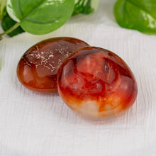 Load image into Gallery viewer, Carnelian Palm Stone on a white cloth - Down to Earth