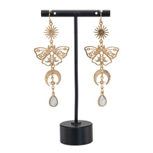 Load image into Gallery viewer, Celestial Sun & Moon Butterfly Earrings on a stand displayed on a white background - Down To Earth