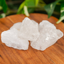 Load image into Gallery viewer, Clear Quartz Raw on a wooden surface close up - Down to Earth