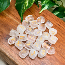 Load image into Gallery viewer, "Set of a Clear Quartz Rune Set on a wooden plank with green foliage in the background," - Down to Earth.