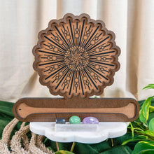 Load image into Gallery viewer, "Crystal Grid Incense Holder with a sunburst design on a white surface with green foliage in the background," - Down to Earth.