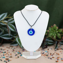 Load image into Gallery viewer, Evil eye dark blue varient necklaces on a white mannequin neck against a green background - Down to Earth