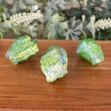 Load image into Gallery viewer, Green Aura Quartz Point front facing on a style background - Down To Earth