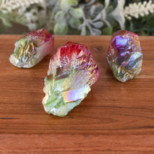 Load image into Gallery viewer, Green & Red Aura Quartz Point front facing on a style background - Down To Earth