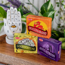 Load image into Gallery viewer, HEM Incense Cones on a wooden surface with burner in the foreground - Down to Earth