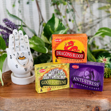 Load image into Gallery viewer, HEM Incense Cones on a wooden surface with burner in the foreground front angle - Down to Earth