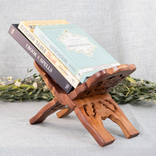 Load image into Gallery viewer, Hand Carved Wooden Book Holder with books side angled displayed on a styled background - Down To Earth