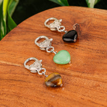 Load image into Gallery viewer, Crystal Heart Pet Pendants group photo on a wooden surface high angle - Down to Earth