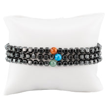 Load image into Gallery viewer, Hematite with Crystal Bead Stretch Bracelet on a white pillow - Down to Earth