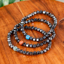 Load image into Gallery viewer, Hematite with Crystal Bead Stretch Bracelet on a wooden surface - Down to Earth