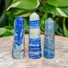 Load image into Gallery viewer, "Three Lapis Lazuli Towers on a wooden base with green foliage in the background," - Up N Smoke.