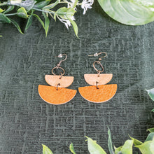 Load image into Gallery viewer, Leather Geometric Semicircle Dangle Earrings top down with plants displayed on a styled background - Down To Earth