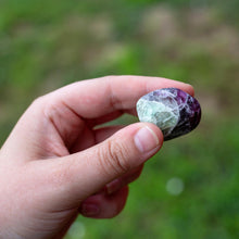 Load image into Gallery viewer, A Piece of Tumbled Fluorite inbetween two fingers - Down To Earth