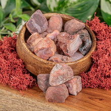 Load image into Gallery viewer, Carnelian Raw crystals displayed on a colorful background close up angle - Down to Earth