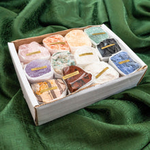 Load image into Gallery viewer, "Set of twelve rough mineral flat crystals in a white box on a green cloth," - Down To Earth