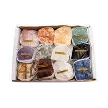 Load image into Gallery viewer, "Set of twelve raw flat crystals in a white box on a white background," - Down to Earth.