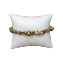 Load image into Gallery viewer, Rhyolite Tumbled Crystal Braceleton a pillow displayed on a white background - Down to Earth