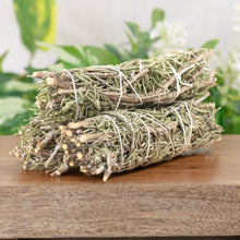 Load image into Gallery viewer, Rosemary Smudge Stick angled displayed on a styled background - Down To Earth