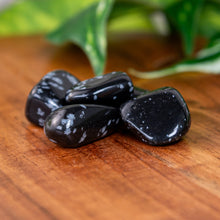 Load image into Gallery viewer, Snowflake Obsidian Tumbled on a wooden surface - Down to Earth