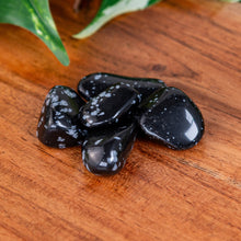 Load image into Gallery viewer, Snowflake Obsidian Tumbled on a wooden surface high angle - Down to Earth