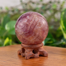 Load image into Gallery viewer, Purple Fluorite 65mm Sphere on a wooden stand different angle - Down to Earth