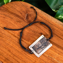 Load image into Gallery viewer, "Bracelet with a rectangular tree pendant on a wooden surface," - Down to Earth.