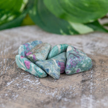 Load image into Gallery viewer, Tumbled Ruby Fuchsite on a wooden surface - Down to Earth