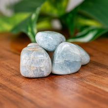 Load image into Gallery viewer, Aquamarine Tumbled on a wooden surface - Down to Earth