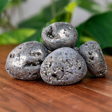 Load image into Gallery viewer, Pyrite Tumbled on a wooden surface - Down to Earth