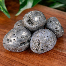 Load image into Gallery viewer, Pyrite Tumbled on a wooden surface high angle - Down to Earth