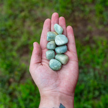 Load image into Gallery viewer, Tumbled Aquamarine in hand - Down To Earth