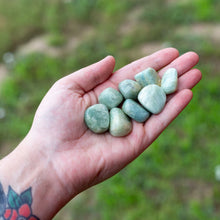 Load image into Gallery viewer, Tumbled Aquamarine in hand - Down To Earth