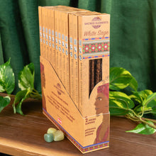 Load image into Gallery viewer, "Display case of White Sage Sacred Elements Incense Sticks on top of a wooden surface with foliage in the background," - Down to Earth.
