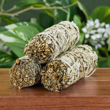 Load image into Gallery viewer, White Sage Smudge Stick 1x4 group photo with plants displayed on a styled background - Down to Earth