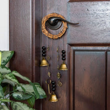 Load image into Gallery viewer, "Decorative door hanger that has bells, black beads, and various witchy charms," - Down to Earth.