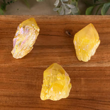 Load image into Gallery viewer, Yellow Aura Quartz Point top down on a style background - Down To Earth
