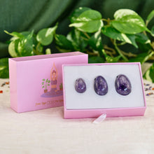 Load image into Gallery viewer, "Three yoni eggs inside a light pink box, propped up against the lid that has a graphic of a woman practicing yoga," - Down to Earth.