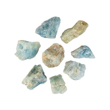 Load image into Gallery viewer, "Eight pieces of raw aquamarine crystals against a white background," - Down to Earth.