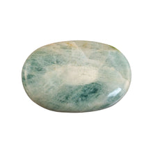 Load image into Gallery viewer, "Aquamarine palm stone in an oval shape on a white background," - Down to Earth.