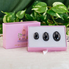 Load image into Gallery viewer, "An open light pink box with a three-piece black obsidian yoni egg set inside," - Down to Earth.