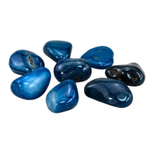 Load image into Gallery viewer, "Side angle of eight pieces of tumbled blue agate against a white background," - Down to Earth.
